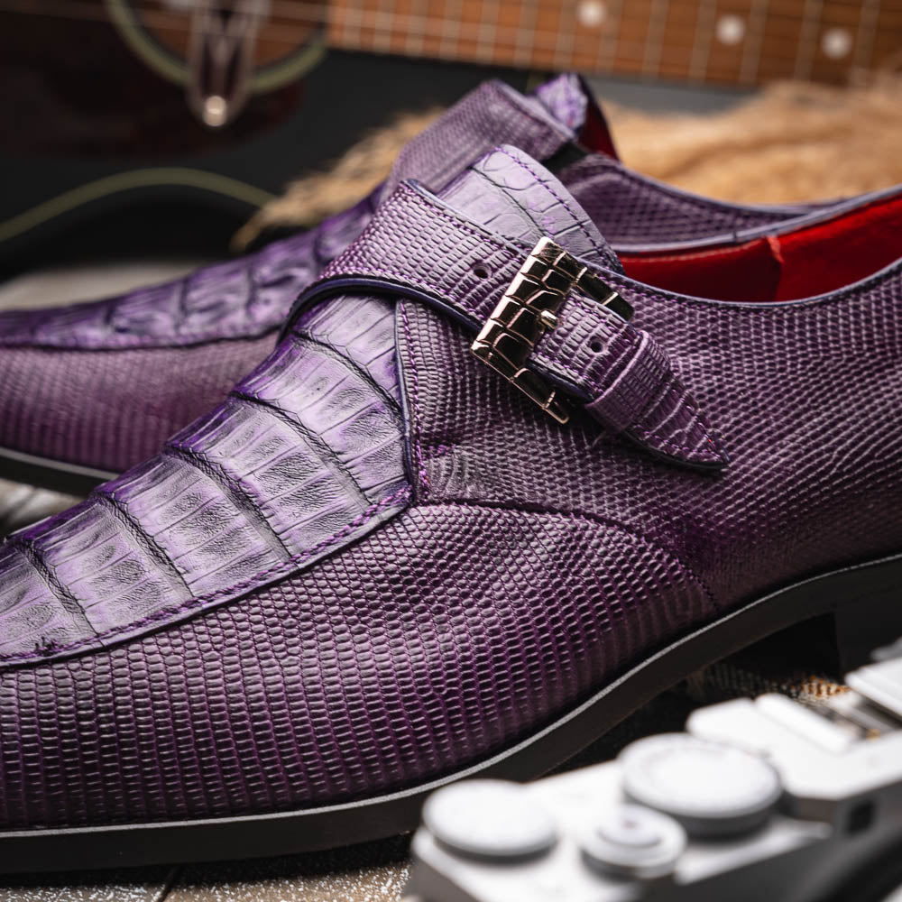 The Toluca Purple by Marco Di Milano is a pair of luxury monk strap shoes with textured purple leather, a silver buckle, red inner lining, and vibrant purple soles—one shoe rests against the other to showcase its unique sole design.