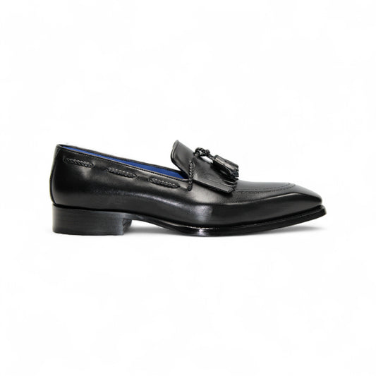 The Emilio Franco Tommaso Black loafer by Emilio Franco features tassel detail, low heel, and stitching accents. Crafted from genuine leather, it's shown from the side on a plain white background.