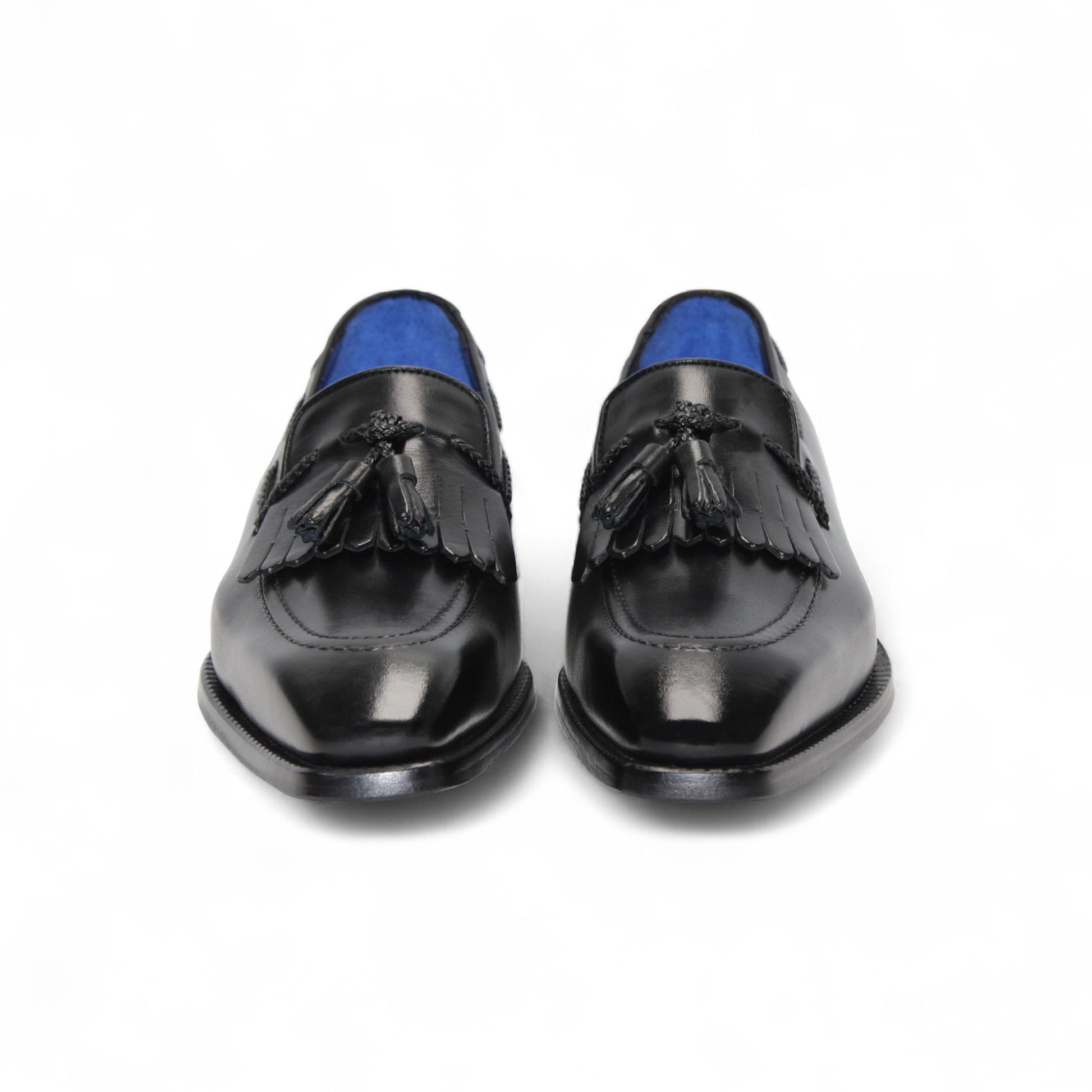 The Emilio Franco Tommaso Black loafer by Emilio Franco features tassel detail, low heel, and stitching accents. Crafted from genuine leather, it's shown from the side on a plain white background.