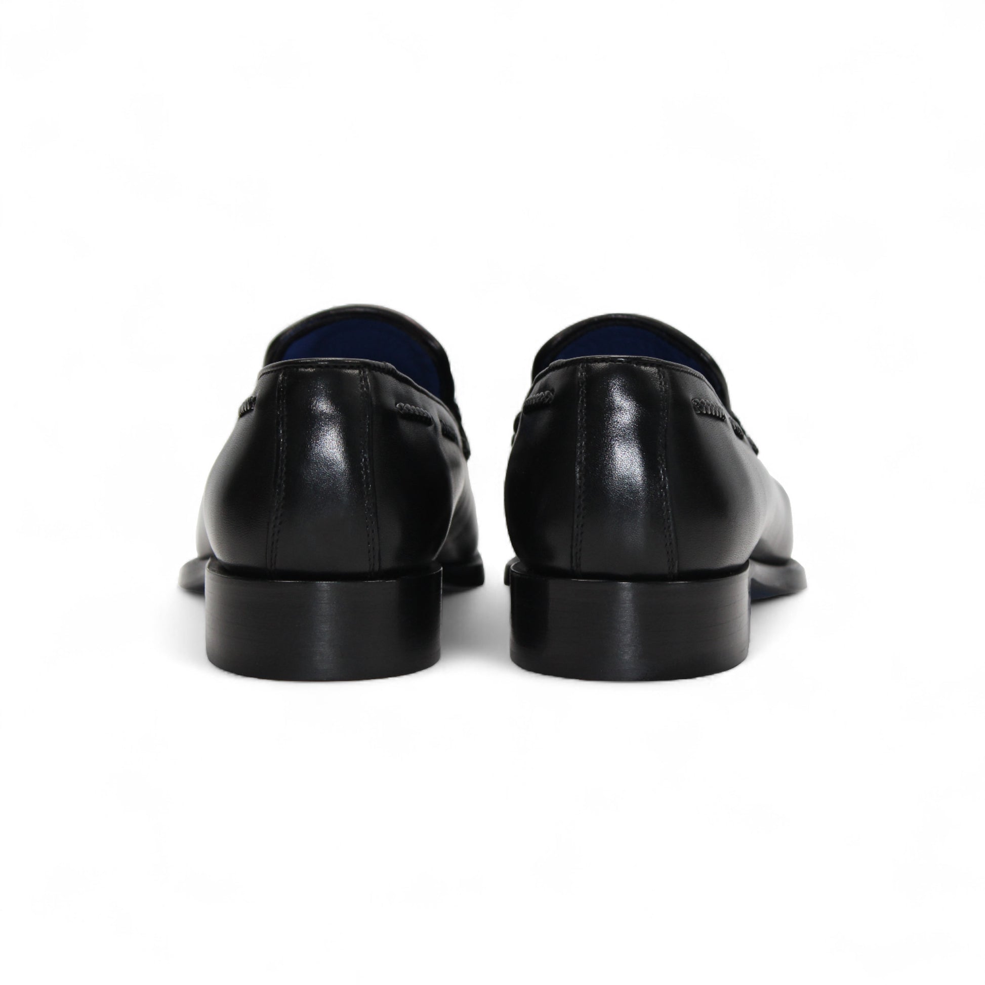 The Emilio Franco Tommaso Black loafer by Emilio Franco features tassel detail, low heel, and stitching accents. Crafted from genuine leather, it's shown from the side on a plain white background.