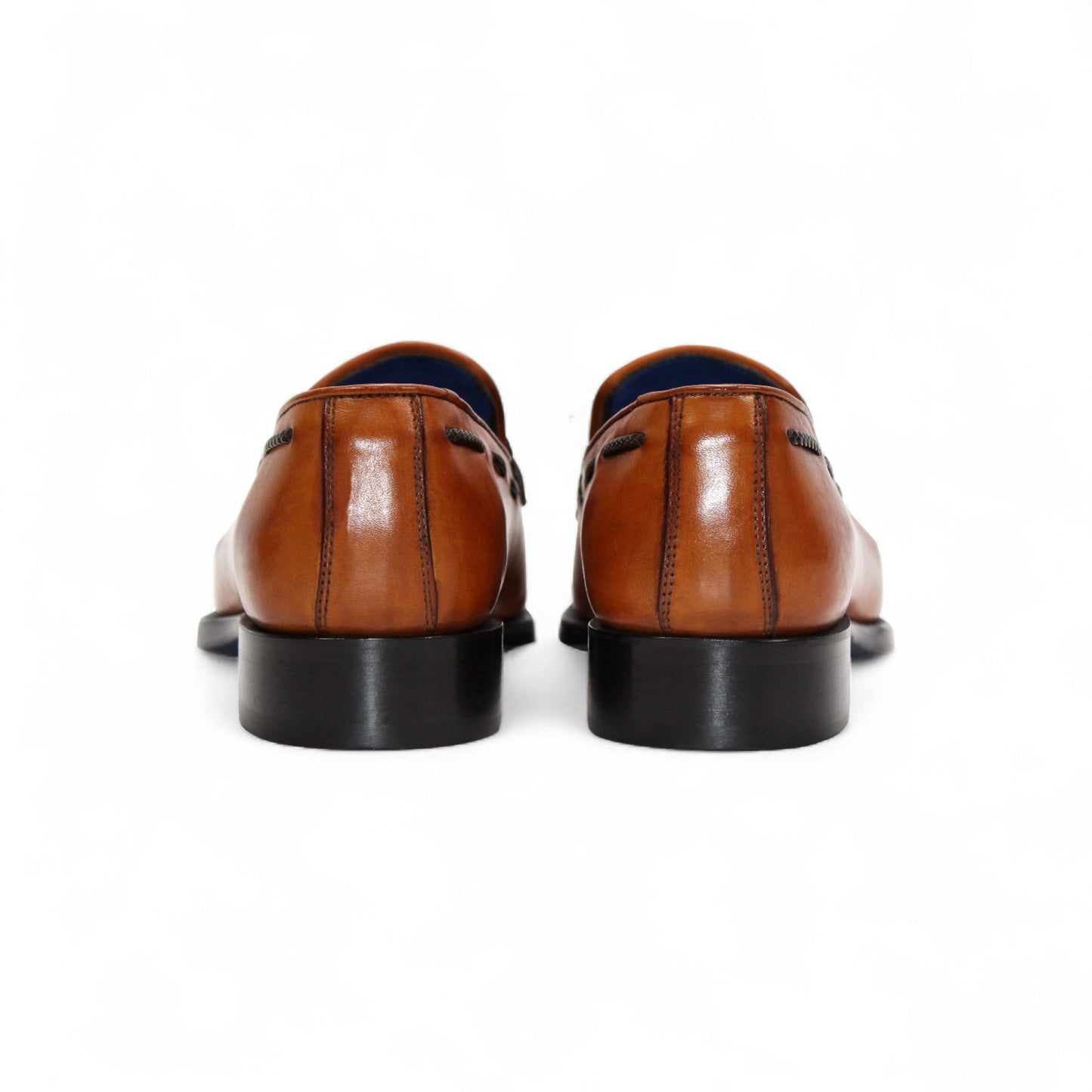 The Emilio Franco Tommaso Gold is a tan leather loafer with a tailored fit, low black heel, tassel detail on the upper, and dark side stitching, shown in side profile against a white background.