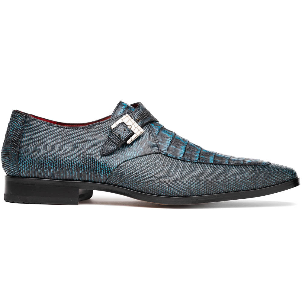 A pair of Toluca Rustic Blue exotic leather dress shoes by Marco Di Milano features a buckle detail, with one shoe on its side showing the tan leather sole and “MARCO DI MILANO” branding.