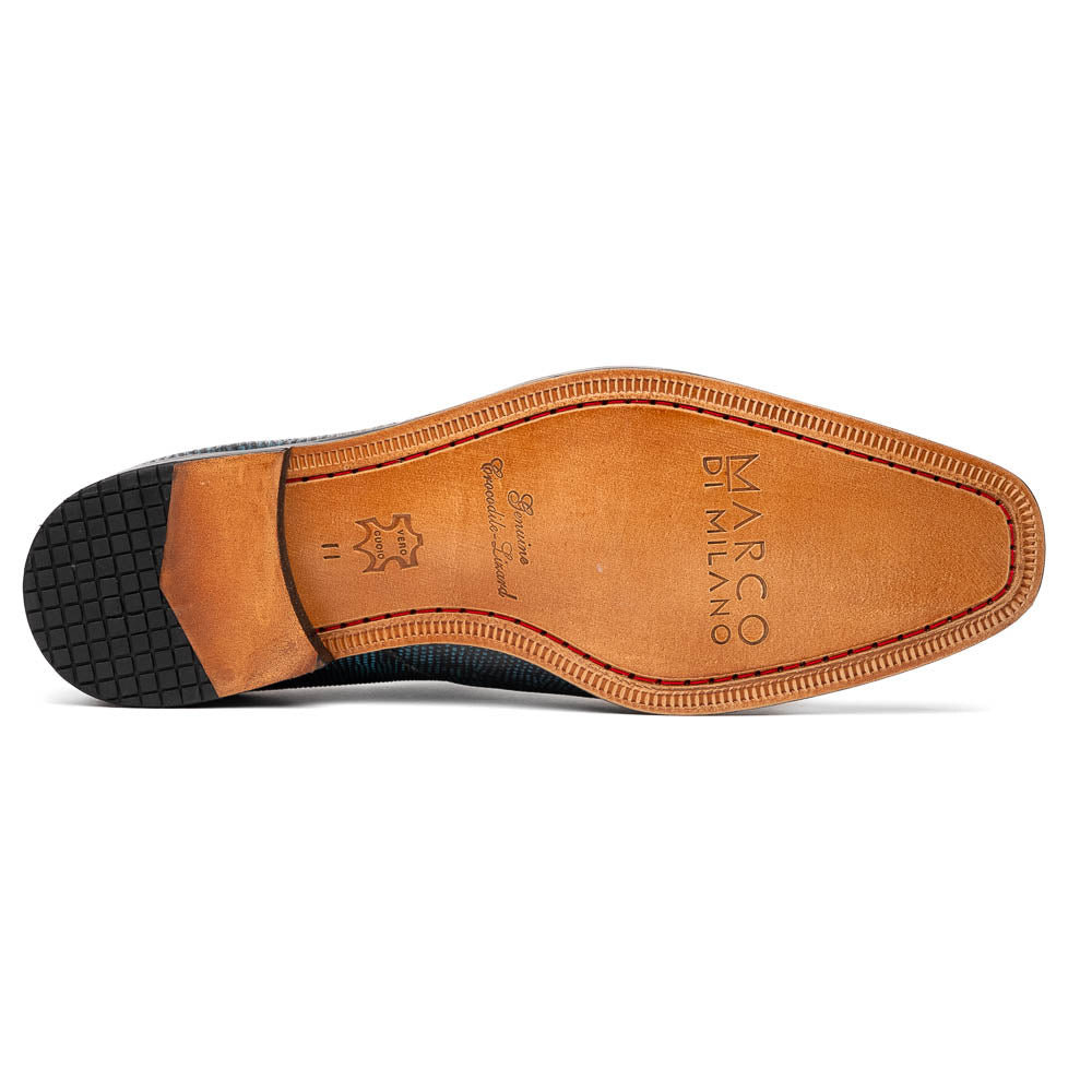 A pair of Toluca Rustic Blue exotic leather dress shoes by Marco Di Milano features a buckle detail, with one shoe on its side showing the tan leather sole and “MARCO DI MILANO” branding.