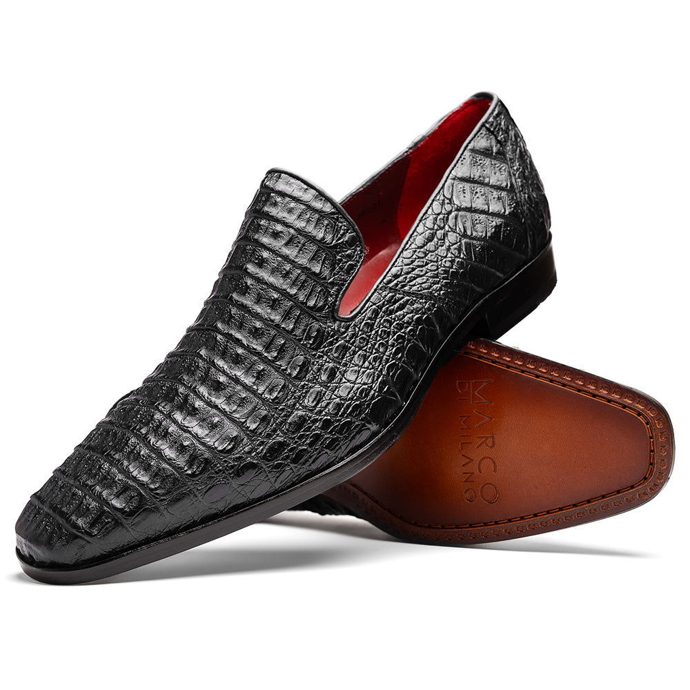 A pair of Marco Di Milano Trento Black loafers crafted from genuine caiman crocodile-pattern leather, showcasing a striking black exterior, red interior lining, and brown soles—one positioned upright and the other on its side. These luxury shoes feature exquisite hand-painted finishes for a truly sophisticated touch.