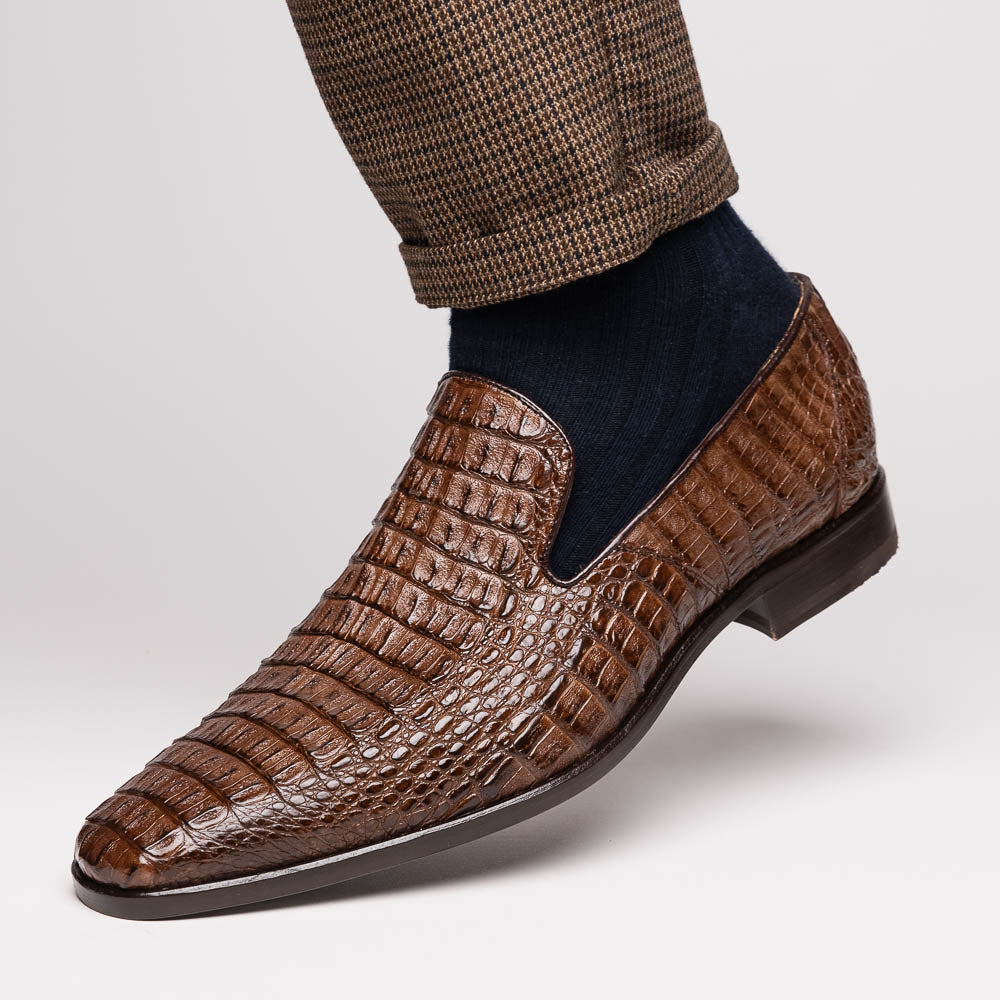 The Marco Di Milano Trento Brown shoes, crafted from genuine caiman crocodile leather, are shown with one upright and one on its side to reveal the sole, highlighting their hand-painted luxury finish.