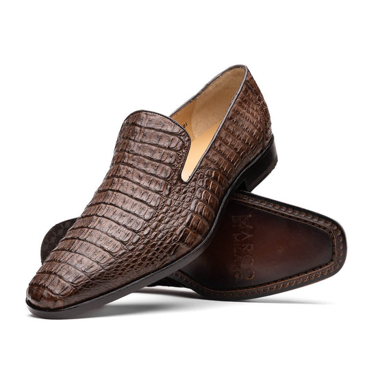 The Marco Di Milano Trento Brown shoes, crafted from genuine caiman crocodile leather, are shown with one upright and one on its side to reveal the sole, highlighting their hand-painted luxury finish.