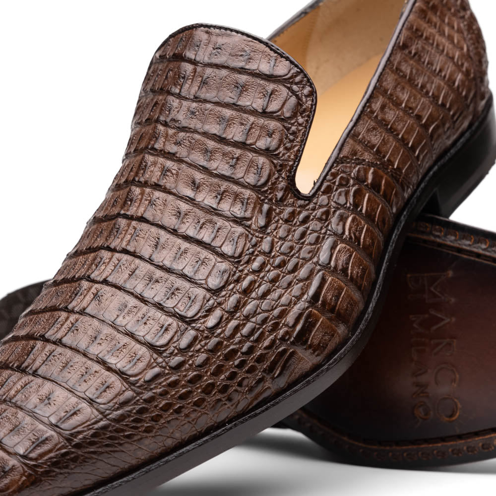 The Marco Di Milano Trento Brown shoes, crafted from genuine caiman crocodile leather, are shown with one upright and one on its side to reveal the sole, highlighting their hand-painted luxury finish.