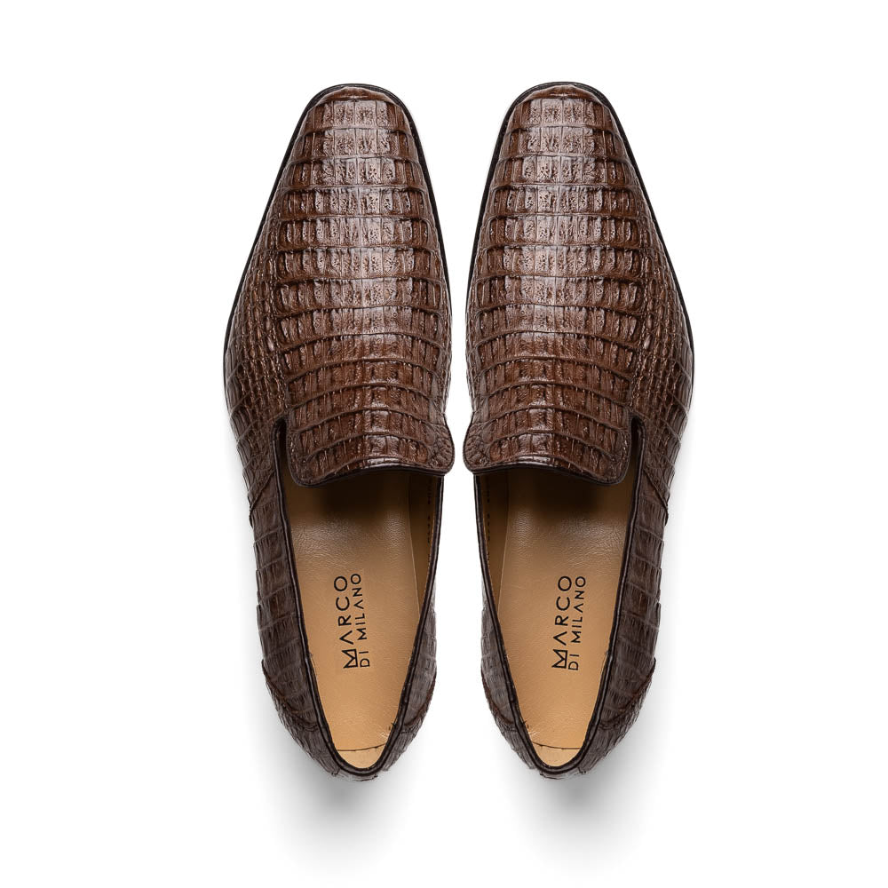 The Marco Di Milano Trento Brown shoes, crafted from genuine caiman crocodile leather, are shown with one upright and one on its side to reveal the sole, highlighting their hand-painted luxury finish.