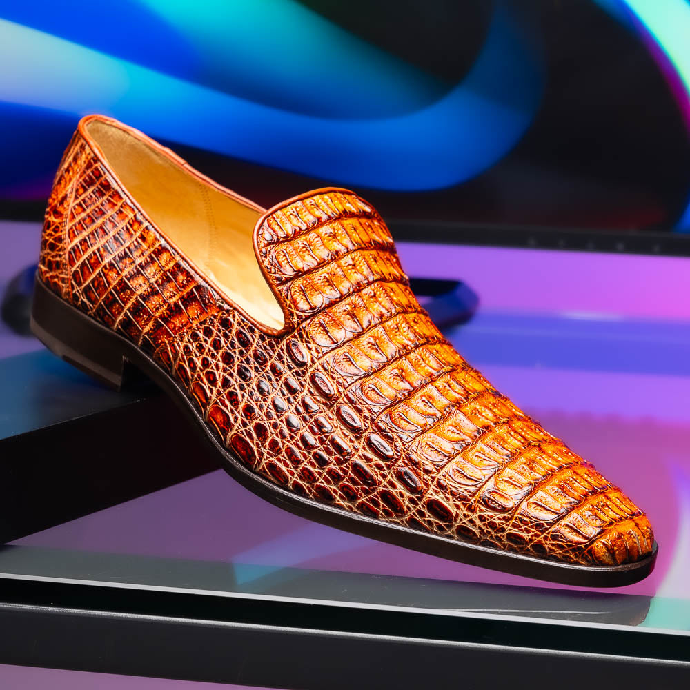 The Marco Di Milano Trento Rustic Cognac shoes, crafted from genuine caiman crocodile leather with a hand-painted finish, are displayed—one upright and one showing the sole—to highlight this luxurious footwear’s exquisite design.