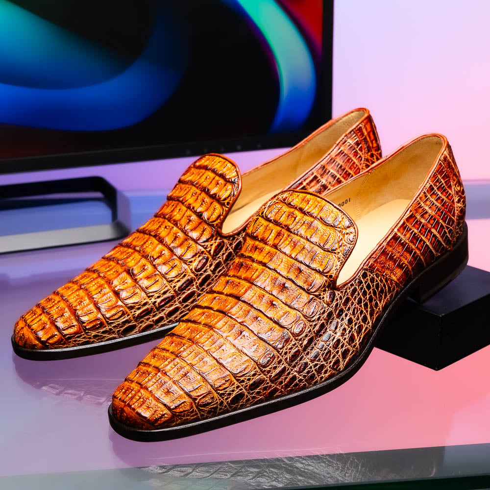 The Marco Di Milano Trento Rustic Cognac shoes, crafted from genuine caiman crocodile leather with a hand-painted finish, are displayed—one upright and one showing the sole—to highlight this luxurious footwear’s exquisite design.