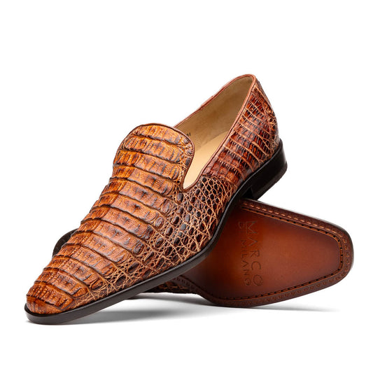 The Marco Di Milano Trento Rustic Cognac shoes, crafted from genuine caiman crocodile leather with a hand-painted finish, are displayed—one upright and one showing the sole—to highlight this luxurious footwear’s exquisite design.