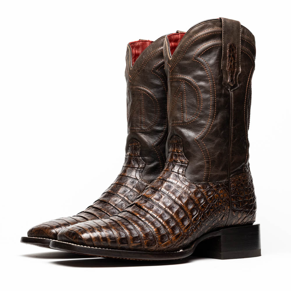 A pair of Marco Di Milano Tucson Aged Brown cowboy boots with textured caiman belly leather—one boot stands upright while the other displays its sole, branded "Marco di Milano.