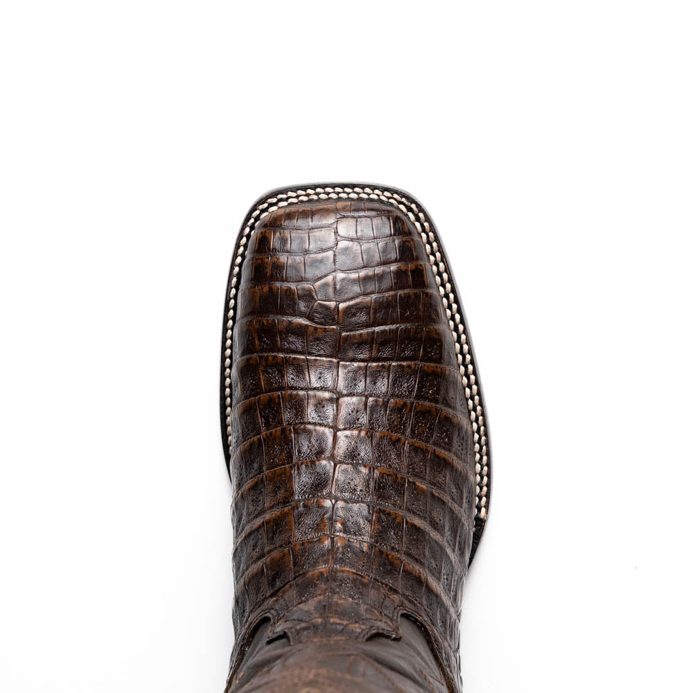 A pair of Marco Di Milano Tucson Aged Brown cowboy boots with textured caiman belly leather—one boot stands upright while the other displays its sole, branded "Marco di Milano.