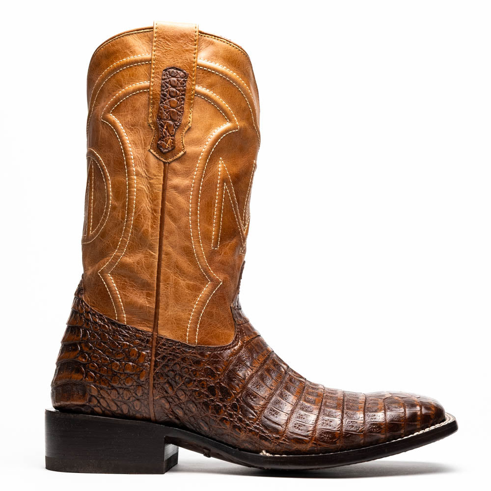A pair of Tucson Aged Maple brown genuine leather western boots by Marco Di Milano with a textured finish; one boot upright, the other displaying the sole with "Marco Di Milano" branding.