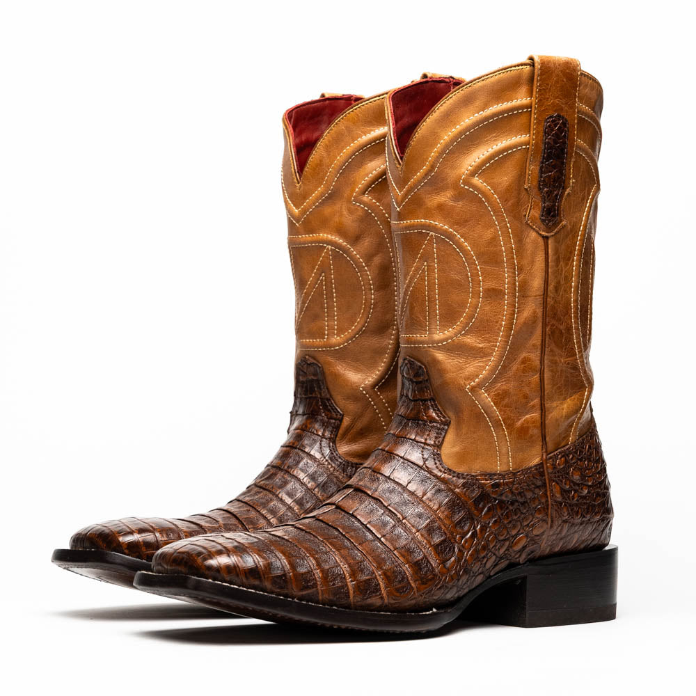A pair of Tucson Aged Maple brown genuine leather western boots by Marco Di Milano with a textured finish; one boot upright, the other displaying the sole with "Marco Di Milano" branding.