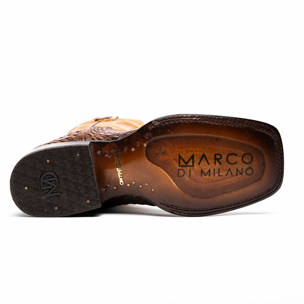 A pair of Tucson Aged Maple brown genuine leather western boots by Marco Di Milano with a textured finish; one boot upright, the other displaying the sole with "Marco Di Milano" branding.