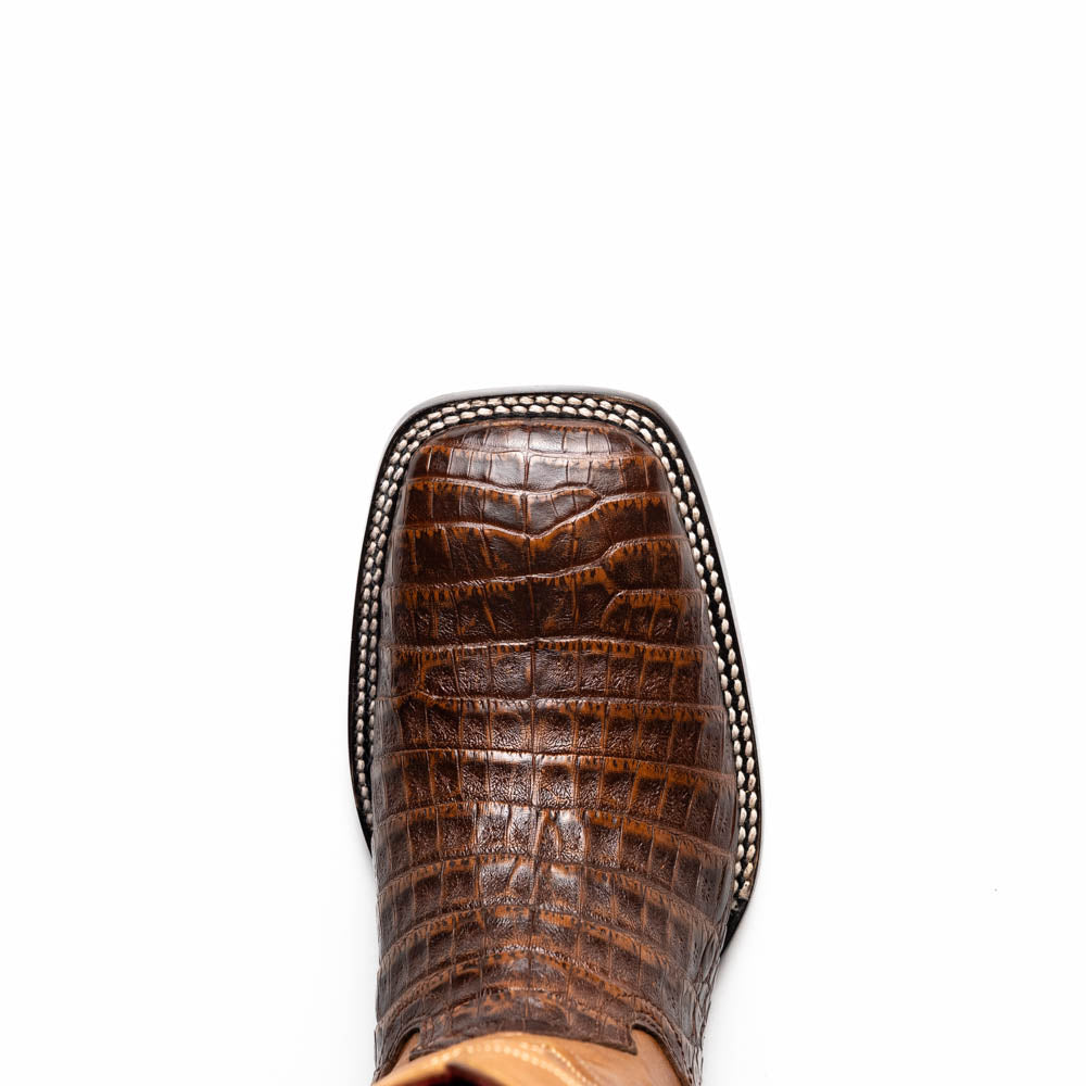 A pair of Tucson Aged Maple brown genuine leather western boots by Marco Di Milano with a textured finish; one boot upright, the other displaying the sole with "Marco Di Milano" branding.
