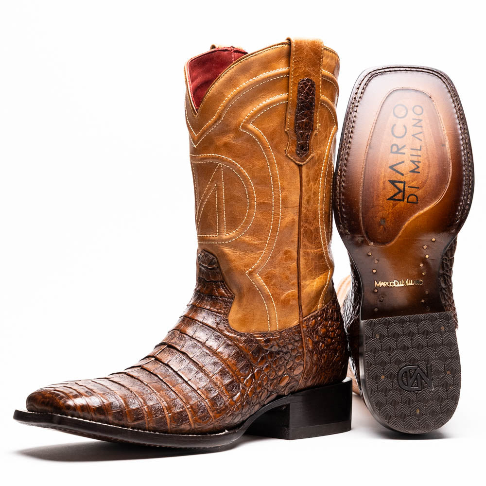 A pair of Tucson Aged Maple brown genuine leather western boots by Marco Di Milano with a textured finish; one boot upright, the other displaying the sole with "Marco Di Milano" branding.