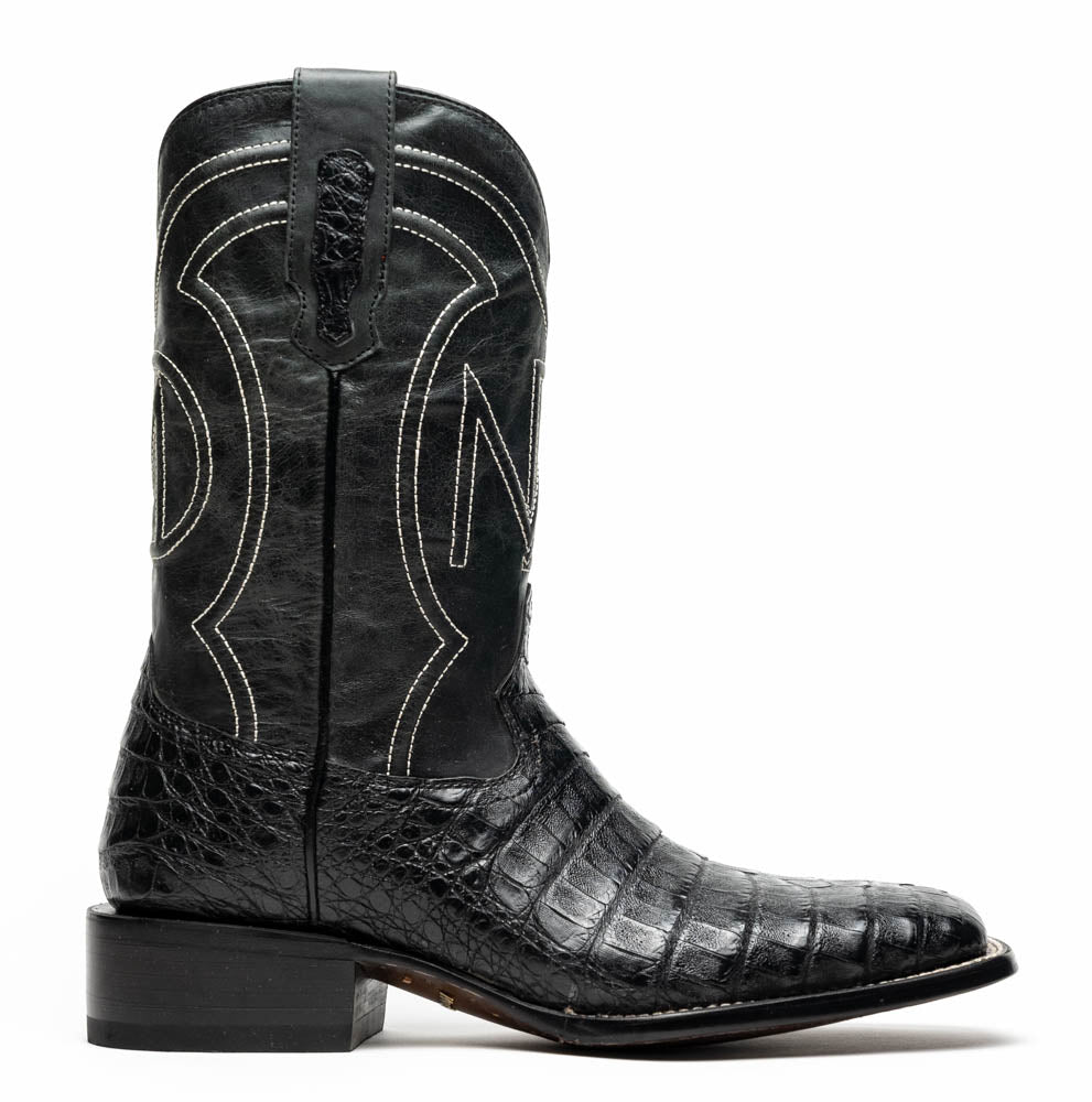 A pair of Tucson Black cowboy boots by Marco Di Milano; one boot stands upright highlighting the decorative stitching, while the other lies on its side showing the branded sole.