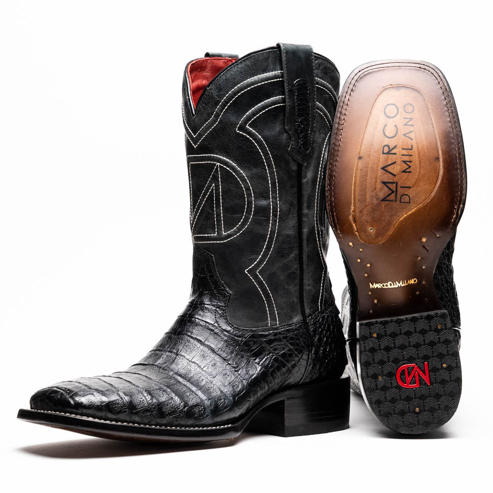 A pair of Tucson Black cowboy boots by Marco Di Milano; one boot stands upright highlighting the decorative stitching, while the other lies on its side showing the branded sole.