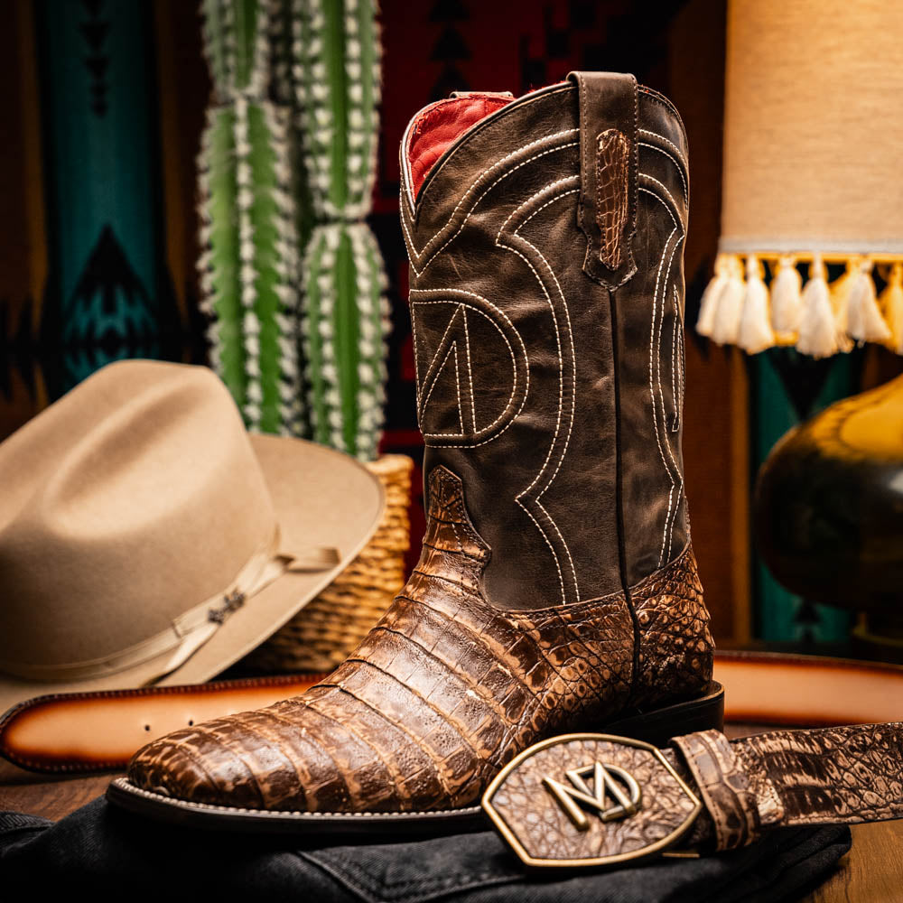 The Marco Di Milano Tucson Stone Orix boots feature genuine caiman belly with brown leather uppers and a crocodile pattern lower, shown from the side and sole.