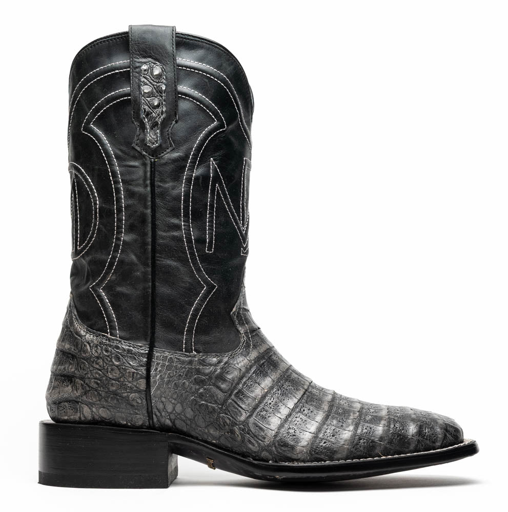 A pair of Tucson Stone Gray cowboy boots by Marco Di Milano with exotic textured leather, detailed white stitching, red inner lining, and the brand logo on the sole.