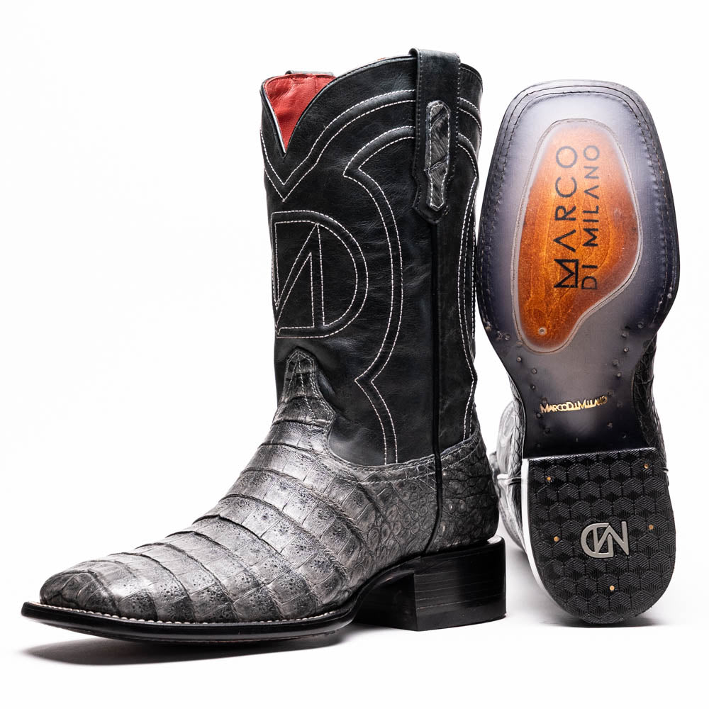 A pair of Tucson Stone Gray cowboy boots by Marco Di Milano with exotic textured leather, detailed white stitching, red inner lining, and the brand logo on the sole.
