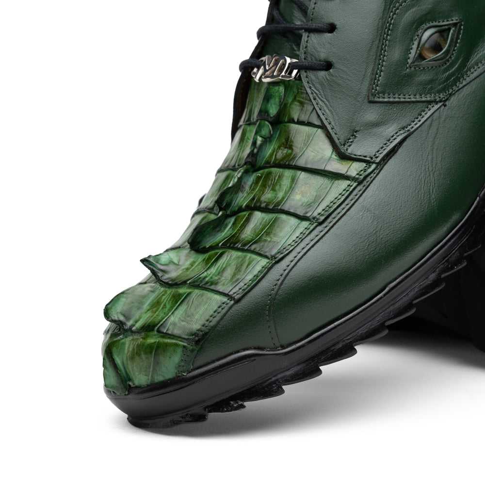 Introducing the Udine Green by Marco Di Milano: luxury men’s shoes in dark green, crafted from exotic hornback caiman leather. These dress shoes showcase a textured, scale-like front design, black laces, and decorative metal initials on the tongue—all displayed against a white background.
