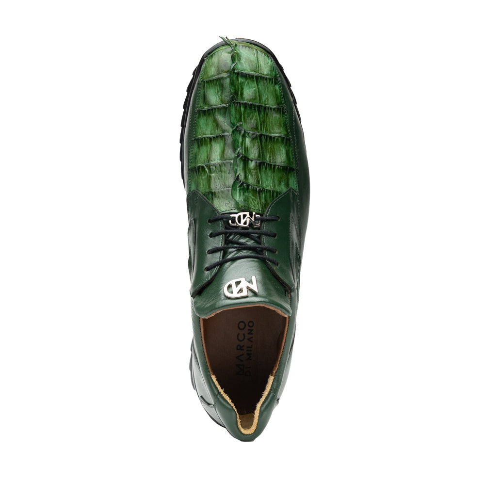 Introducing the Udine Green by Marco Di Milano: luxury men’s shoes in dark green, crafted from exotic hornback caiman leather. These dress shoes showcase a textured, scale-like front design, black laces, and decorative metal initials on the tongue—all displayed against a white background.