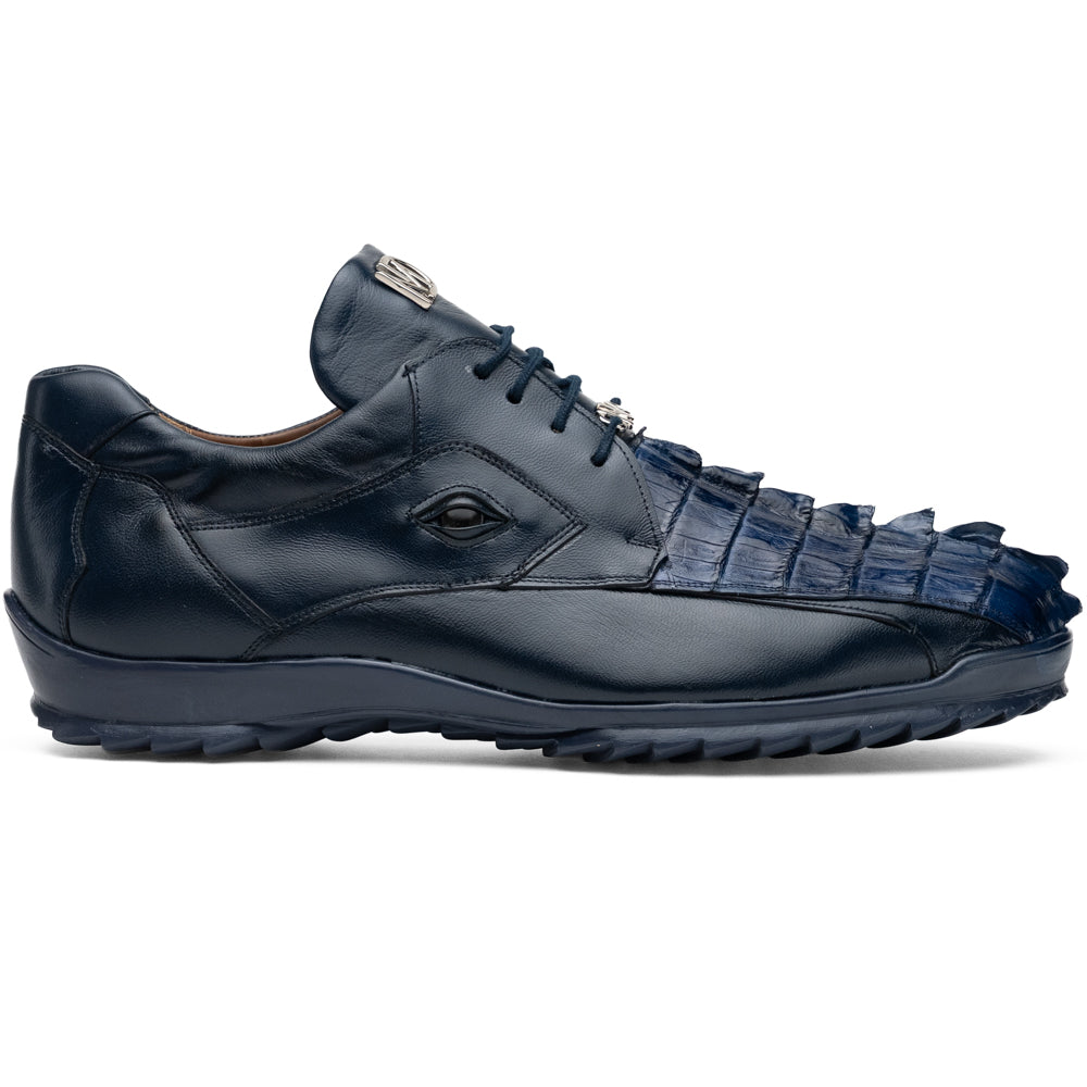 Introducing the Udine Navy by Marco Di Milano—a pair of luxury men’s sneakers crafted from exotic navy blue leather with textured uppers and durable rubber soles. One shoe stands upright while the other rests on its side, showcasing their distinctive style and impeccable craftsmanship.
