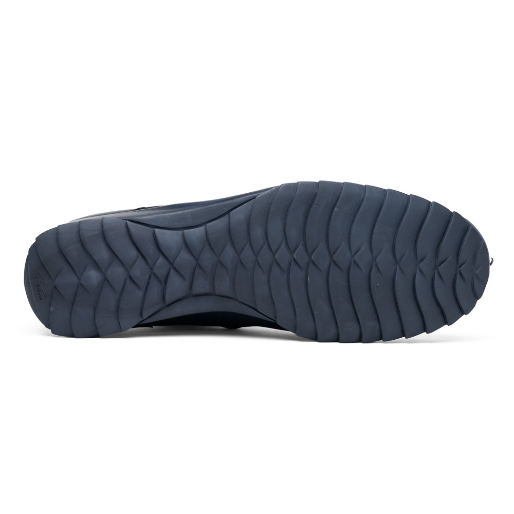 Introducing the Udine Navy by Marco Di Milano—a pair of luxury men’s sneakers crafted from exotic navy blue leather with textured uppers and durable rubber soles. One shoe stands upright while the other rests on its side, showcasing their distinctive style and impeccable craftsmanship.