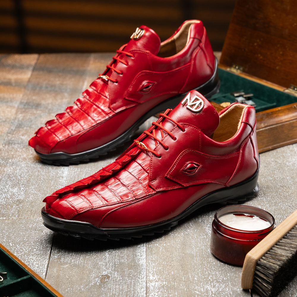 A pair of Marco Di Milano Udine Red glossy hornback caiman sneakers with lace-up fronts, featuring textured detailing and black rubber soles, one luxury men’s sneaker resting elegantly on the other.