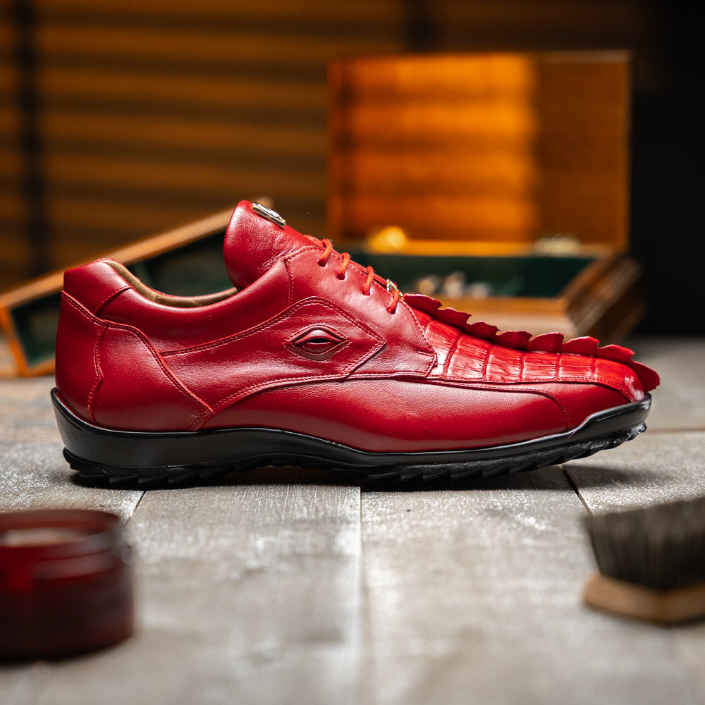 A pair of Marco Di Milano Udine Red glossy hornback caiman sneakers with lace-up fronts, featuring textured detailing and black rubber soles, one luxury men’s sneaker resting elegantly on the other.