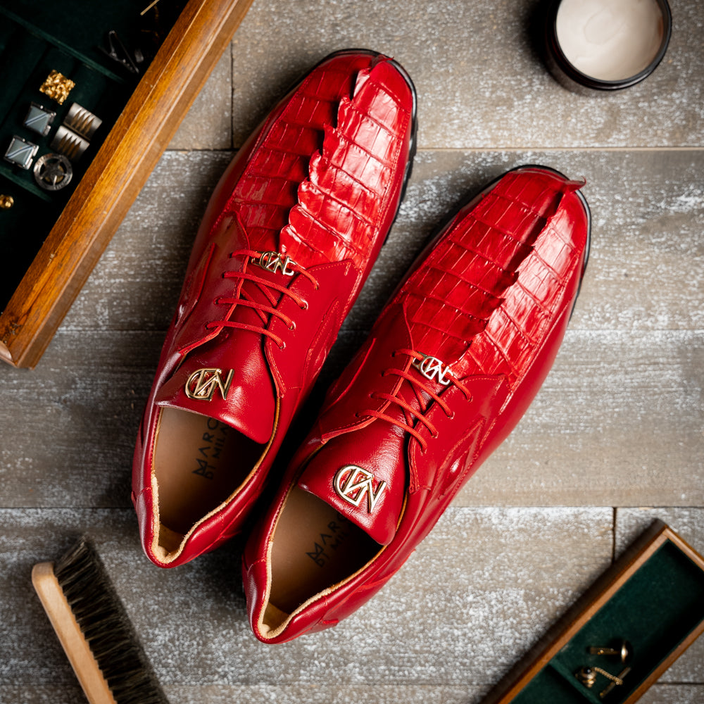 A pair of Marco Di Milano Udine Red glossy hornback caiman sneakers with lace-up fronts, featuring textured detailing and black rubber soles, one luxury men’s sneaker resting elegantly on the other.