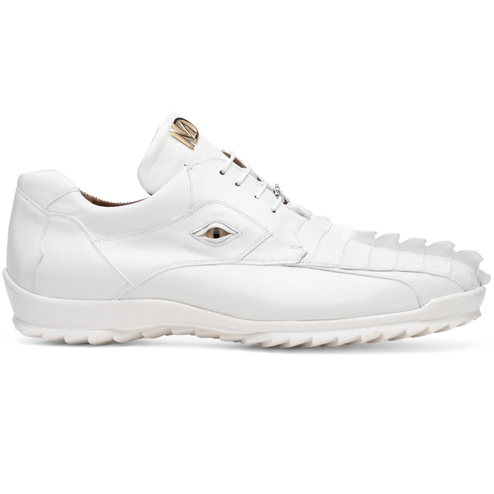 The Udine White by Marco Di Milano is a pair of luxury men’s sneakers crafted from white hornback caiman leather with a distinctive crocodile pattern, featuring a gold logo on the tongue and textured rubber soles. Displayed with one shoe upright and the other leaning against it, this footwear exudes sophistication and unique style.