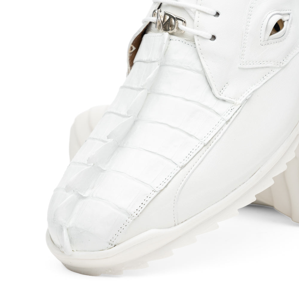 The Udine White by Marco Di Milano is a pair of luxury men’s sneakers crafted from white hornback caiman leather with a distinctive crocodile pattern, featuring a gold logo on the tongue and textured rubber soles. Displayed with one shoe upright and the other leaning against it, this footwear exudes sophistication and unique style.