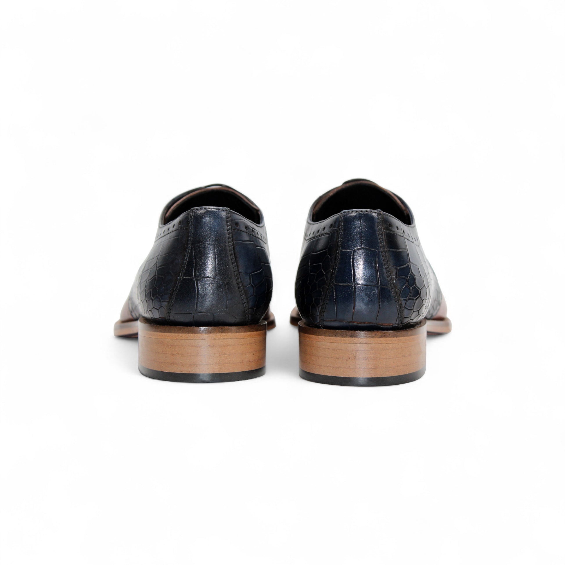 The Duca Di Matiste Duca Valentano Navy/Brandy is a men’s dress shoe in navy with brandy accents, crafted from genuine leather with croco embossing, laces, and a wooden sole, shown in profile against a white background.