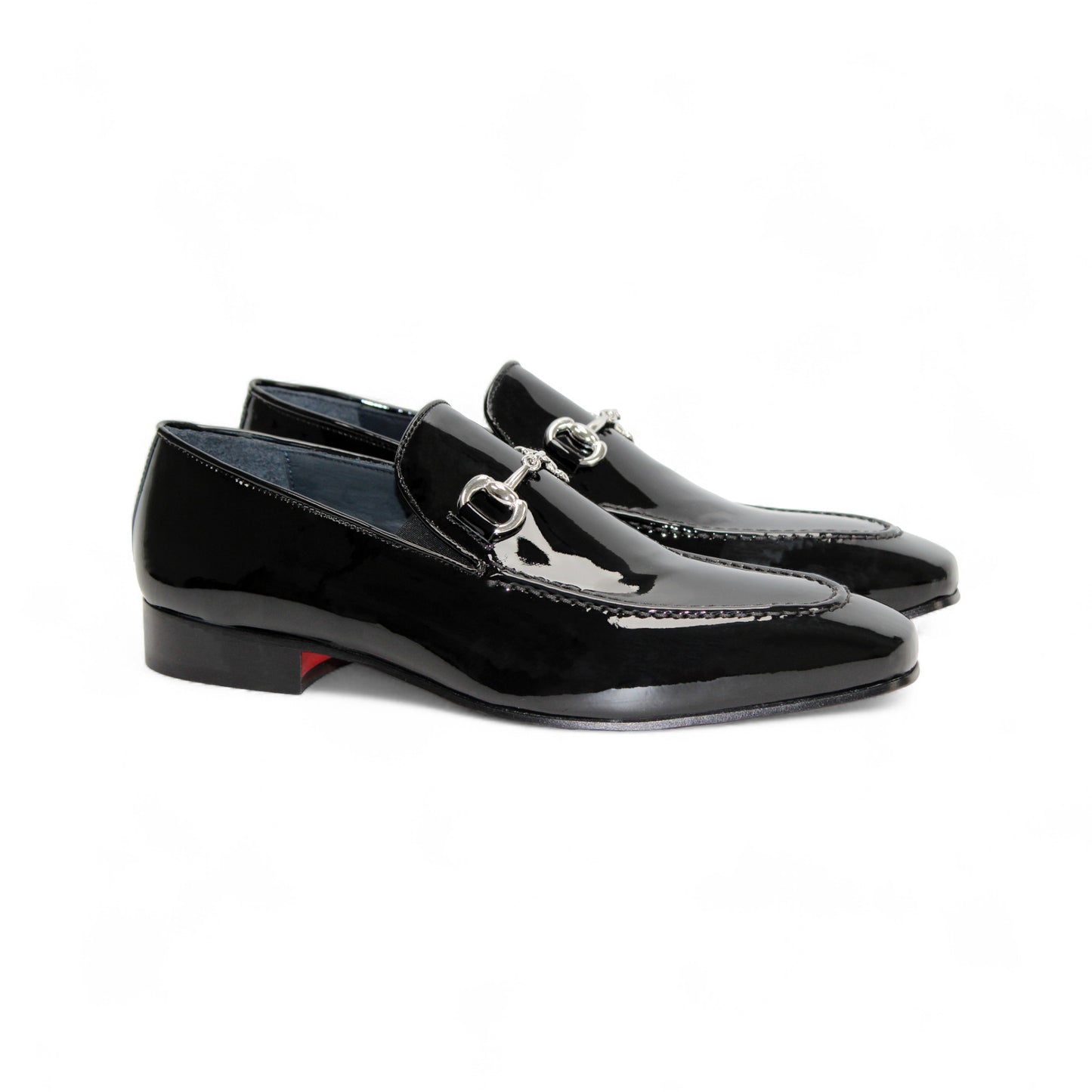 The Duca Di Matiste Duca Valenza Black is an Italian patent leather loafer with a low heel and metal horsebit detail, shown in side profile on a white background—an elegant, timeless designer shoe.