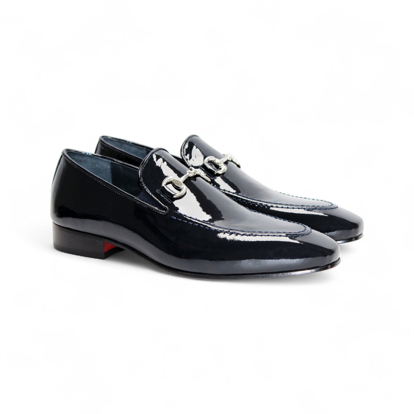 The Duca Valenza Navy by Duca Di Matiste is a navy Italian patent leather loafer with a silver buckle and low heel, shown on a white background—a refined pick for those who appreciate modern elegant shoes.
