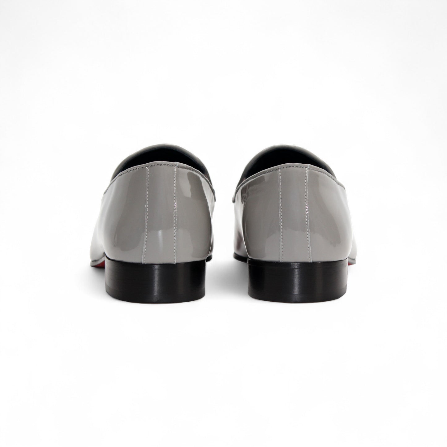 The Duca Di Matiste Duca Valenza Grey loafer features a glossy light gray finish, metal bit detail, black sole, and low heel—exemplifying Italian craftsmanship in luxury footwear. Shown in side profile on a white background.