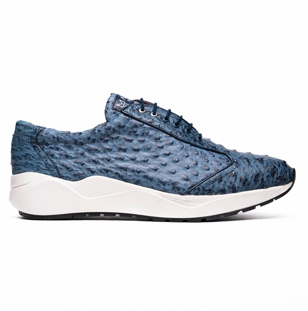 A pair of Marco Di Milano Varenna Blue Jeans sneakers—blue handcrafted leather with white soles and black laces—one upright, the other propped to display its sole.