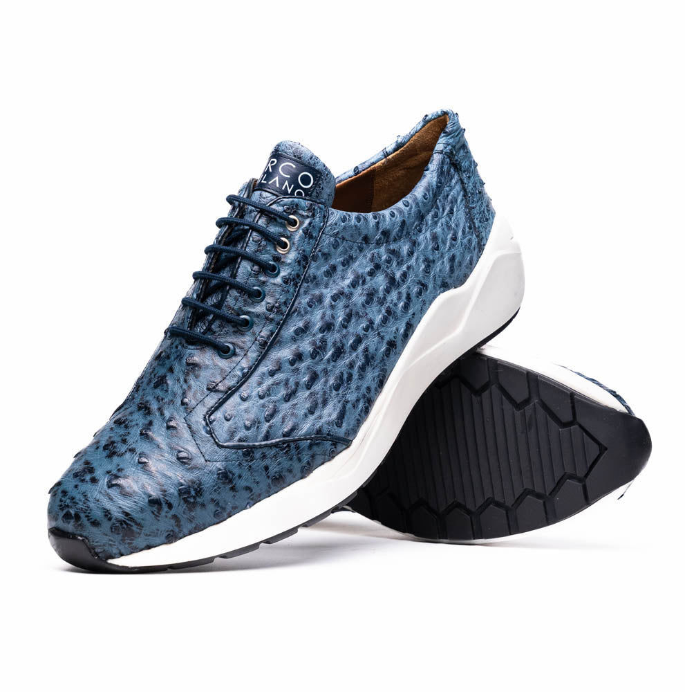 A pair of Marco Di Milano Varenna Blue Jeans sneakers—blue handcrafted leather with white soles and black laces—one upright, the other propped to display its sole.