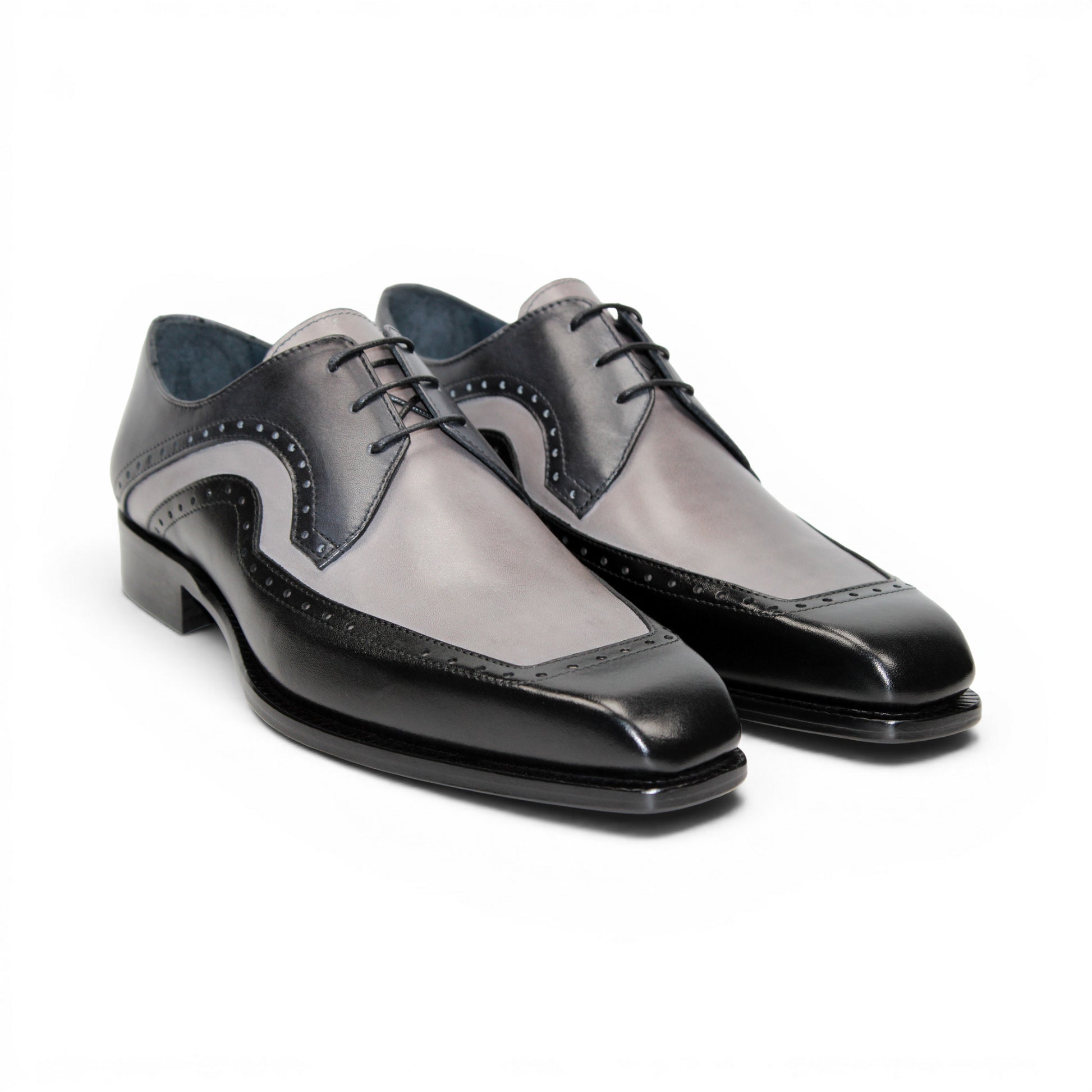 The Duca Di Matiste Duca Velletri Black Combo is a black and gray calf leather dress shoe with brogue detailing, lace-up closure, and low heel, shown side profile on white for timeless style.