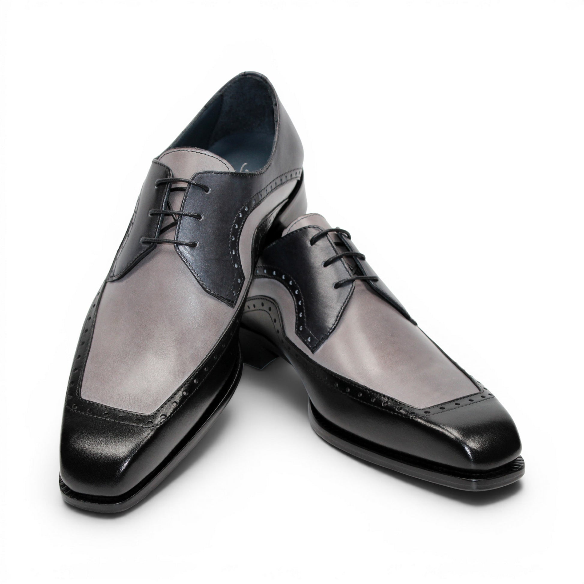 The Duca Di Matiste Duca Velletri Black Combo is a black and gray calf leather dress shoe with brogue detailing, lace-up closure, and low heel, shown side profile on white for timeless style.