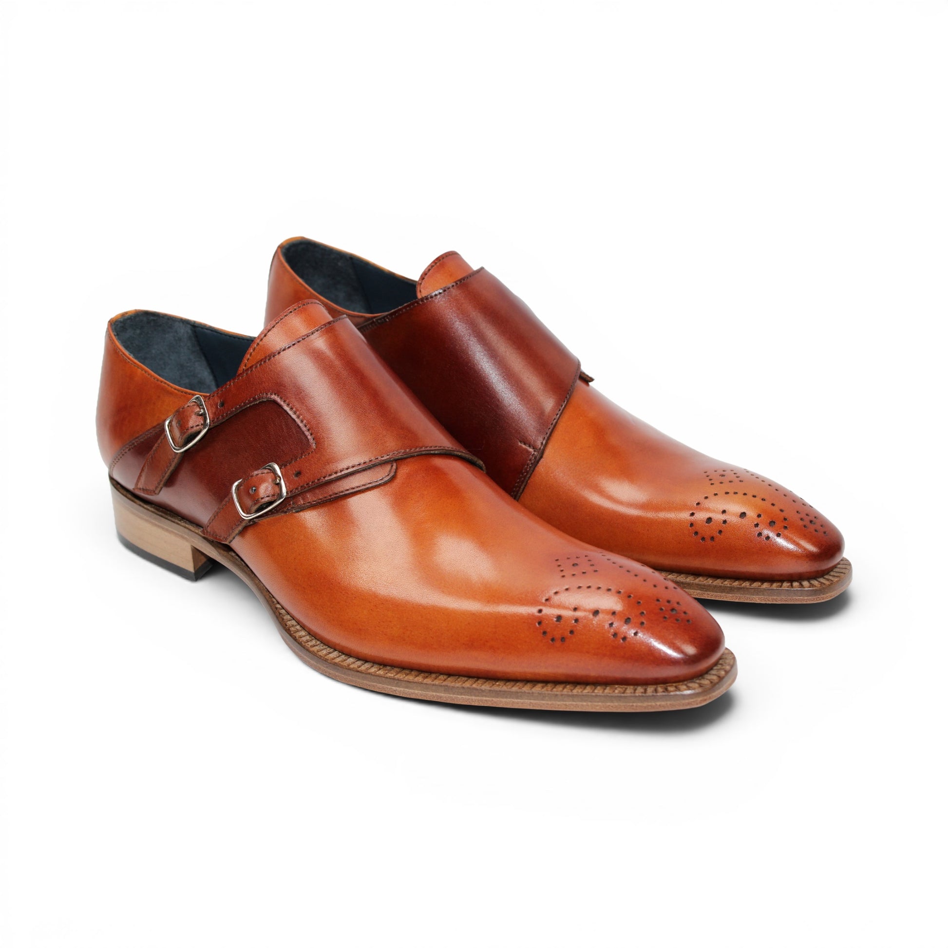 The Duca Vergato Gold/Brown by Duca Di Matiste is an Italian leather monk strap dress shoe in brown, featuring two buckles and decorative perforations on the toe, displayed on a white background.
