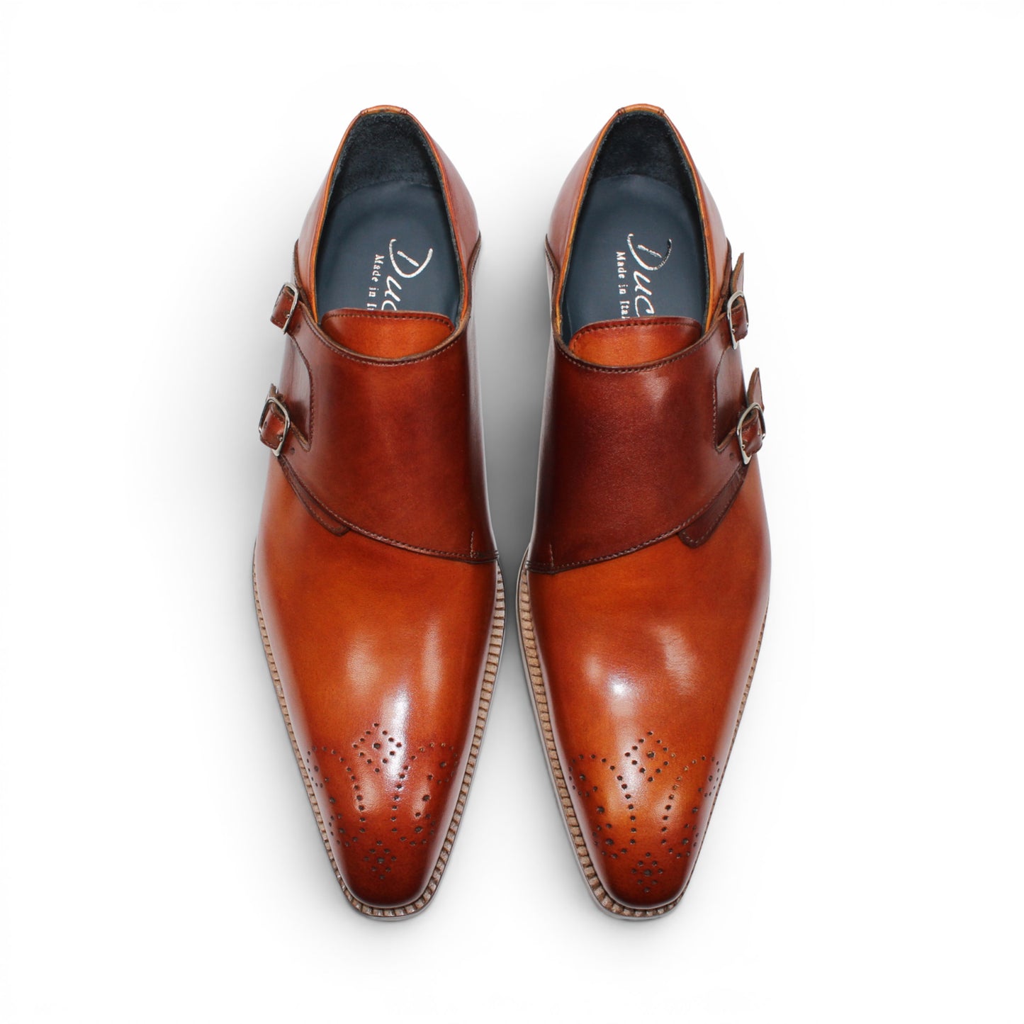 The Duca Vergato Gold/Brown by Duca Di Matiste is an Italian leather monk strap dress shoe in brown, featuring two buckles and decorative perforations on the toe, displayed on a white background.