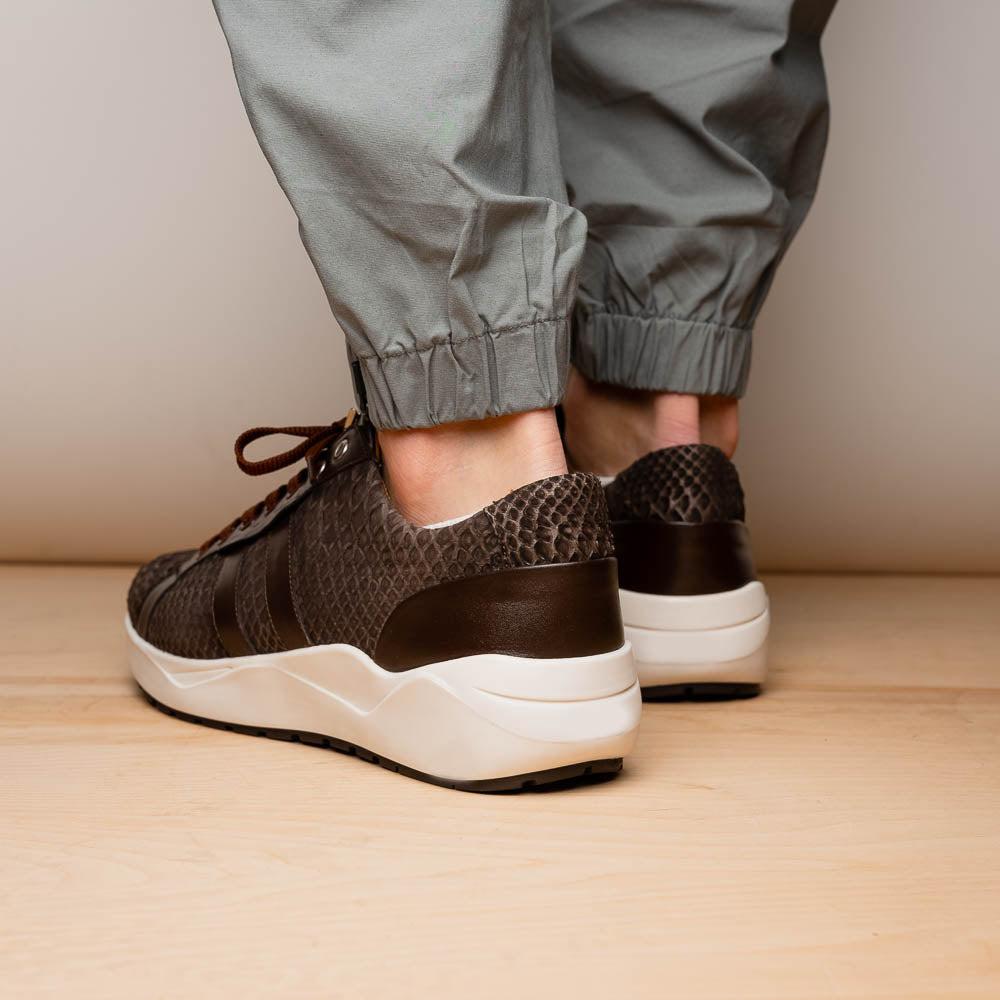 The Verona Brown sneakers by Marco Di Milano are luxury men's shoes crafted in brown sueded python with a snakeskin pattern, white soles, brown laces, and a metal tongue accent—perfect for standout style.