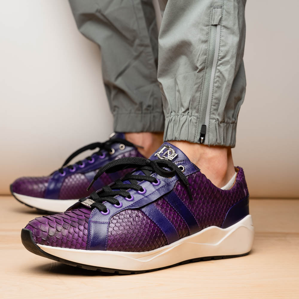 The Verona Purple by Marco Di Milano are hand-painted python sneakers with a textured scale pattern, black laces, and white soles—ideal for elevating any men's sneaker collection. One shoe stands while the other lies on its side.