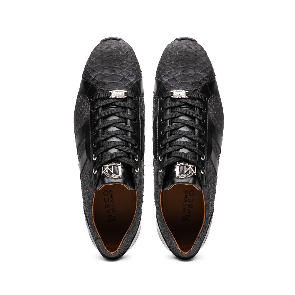 The Verona Black sneakers by Marco Di Milano feature a black textured design, white soles, black laces, and dual black side stripes; one shoe stands upright, while the other lies on its side displaying the sole.