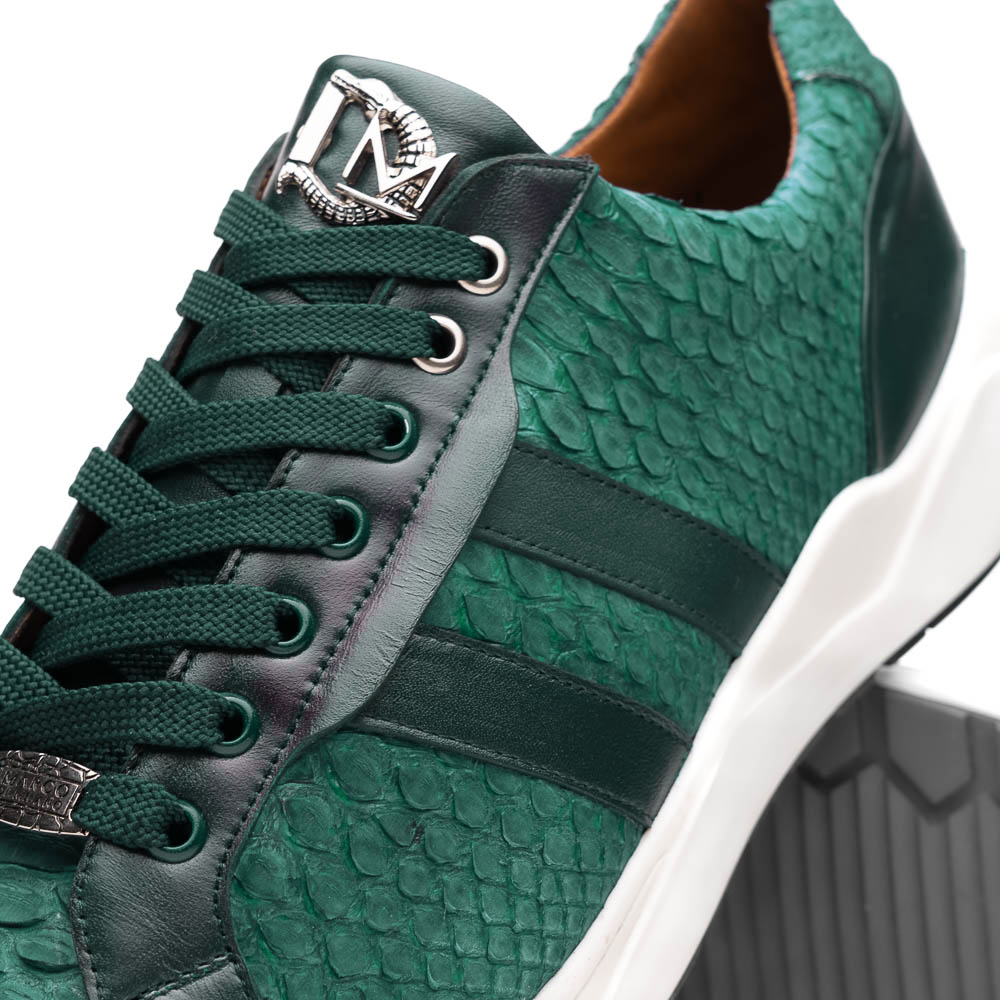 The Marco Di Milano Verona Green sneakers are luxury shoes with scale-like patterns, dark green accents, and white soles. One shoe is upright while the other lies on its side.
